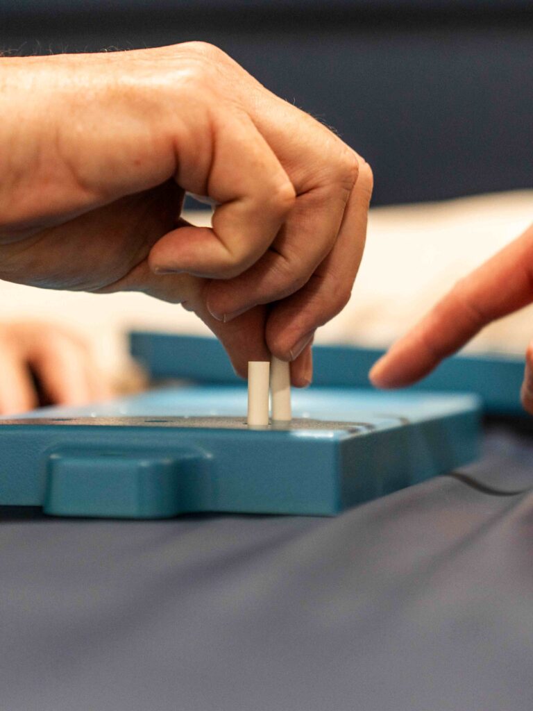 Person performing a Parkinson’s-specific exercise, stretching arms forward while standing.