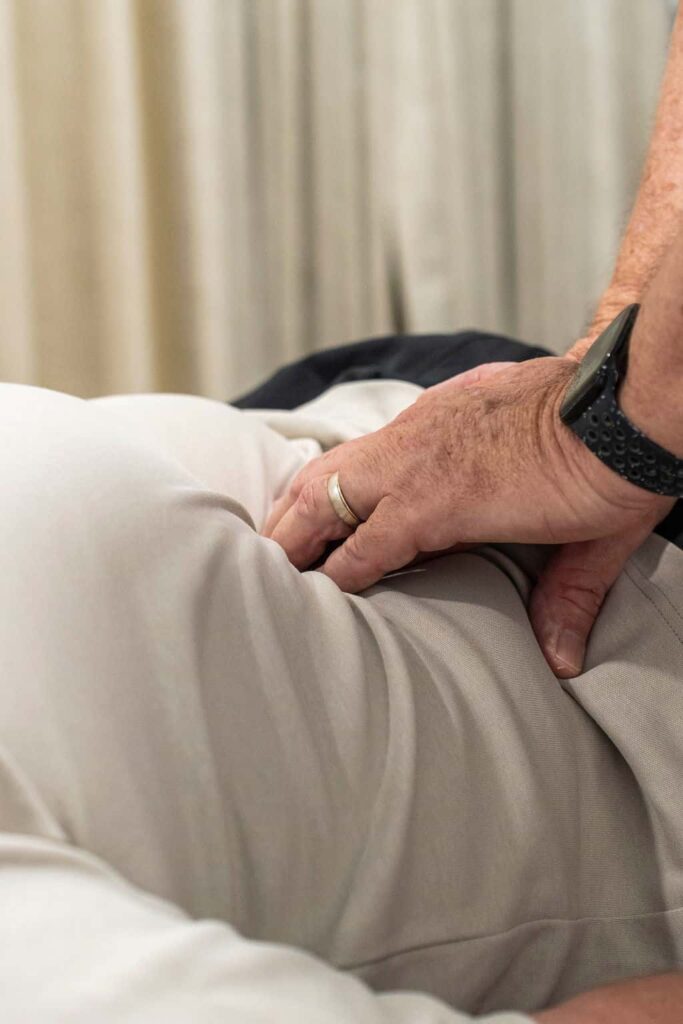 Physiotherapist providing hands-on treatment to a patient during post-surgery rehabilitation.